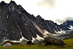Nahanni-National-Park-Reserve-of-Canada-Mountains-rock-sharp-mountain-peaks-snow-closed-sky-with-clouds